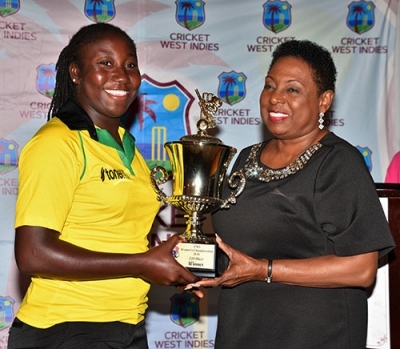 The Honourable Olivia Grange, Minister of Culture, Gender, Entertainment and Sport (right) presents Stafanie Taylor, Jamaica Women’s Cricket Team Captain with the winner’s trophy for Jamaica coming out on top in the Cricket West Indies Regional T20 Blaze tournament played in Jamaica in June. The award was presented during the Closing Ceremony for the tournament at Hotel Four Seasons on Sunday, June 24.