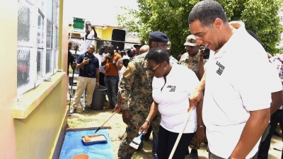 Prime Minister, the Most Honourable Andrew Holness (right) and Minister of Culture, Gender, Entertainment and Sport, the Honourable Olivia Grange, participate in Labour Day activities