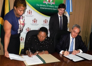 The Honourable Olivia Grange, Minister of Culture, Gender, Entertainment and Sport and His Excellency Ariel Fernandez, Argentinian Ambassador to Jamaica today (December 7) sign an Agreement on Cooperation in the Fields of Art and Culture. The signing was witnessed by Dr Janice, Lindsay, Permanent Secretary (Acting) in the Ministry of Culture, Gender, Entertainment and Sport (left) and Fernando Cané, Chargé d’ Affaires (Acting), Embassy of Argentina (right).