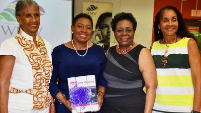 The Honourable Olivia Grange, Minister of Culture, Gender, Entertainment and Sport (second left) with Judith Wedderburn, Director, WMW Jamaica; Elaine Commissiong, Regional Coordinator and Consultant, Media and Development Programme, WMW Jamaica and Elaine Wint, Transformational Trainer (left to right) at the WMW Jamaica Forum held at CARIMAC Annex 11, University of the West Indies, Mona on Wednesday. Minister Grange was presented with a publication from WMW Jamaica titled, “Whose Perspective? A Guide to Gender Aware Analysis of Media Content.