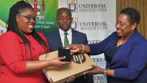 The Honourable Olivia Grange, Minister of Culture, Gender, Entertainment and Sport (right) accepts the donation of laptops and tablets from Deleen Powell, marketing Manager, Universal Service Fund while the Minister of State in the Ministry of Foreign Affairs and Foreign trade and Chairman of the Youth Advisory Committee of the Jamaica National Commission for UNESCO, the Senator the Honourable Pearnel Charles Jr looks on.