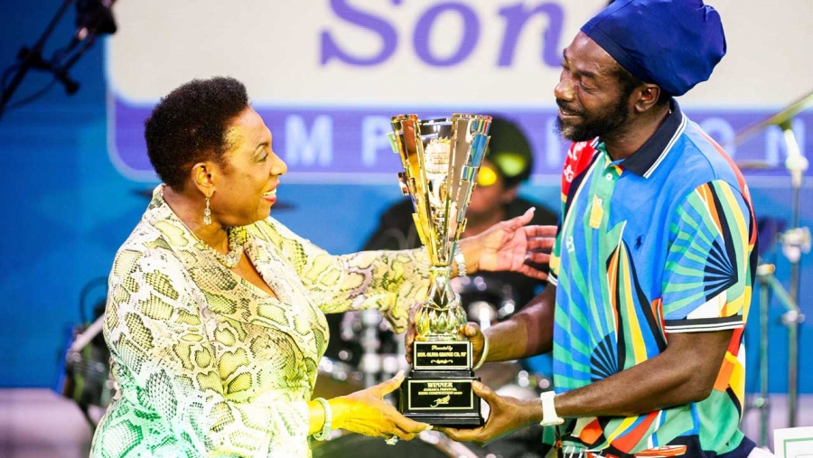 The Minister of Culture, Gender, Entertainment and Sport, the Honourable Olivia Grange (left) presents the Jamaica Festival Song trophy to Buju Banton. The Reggae singer was named winner of the competition on Sunday (July 26) following a public vote.