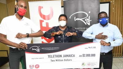The Minister of Culture, Gender, Entertainment and Sport, the Honourable Olivia Grange (centre) does elbow bumps with with the Brand Manager of the Restaurants of Jamaica Group, Andrei Roper (left) and the Chief Executive Officer of the National Health Fund, Everton Anderson on Friday at her offices in New Kingston.  Restaurants of Jamaica presented a symbolic cheque of J$2M to Telethon Jamaica to provide PPE for frontline workers.  The NHF is the government agency procuring the PPE. 