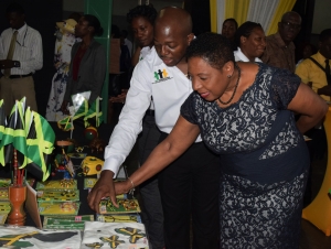 The Honourable Olivia Grange, Minister of Culture, Gender, Entertainment and Sport is impressed by these exhibits at the We Transform Youth Empowerment and Reintegration Programme Competition and Expo at the headquarters of the Girl Guides Association earlier today (Wednesday).  The exhibits were the work of wards of competing correctional institutions. Minister Grange was taken around booths by Senator the Honourable Pearnel Charles Jr., Minister of State in the Ministry of National Security, under which the programme falls. Items included: clothing, art and craft, jewelry and food.  