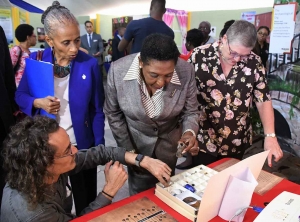 The Honourable Olivia Grange, Minister of Culture, Gender, Entertainment and Sport, examines artefacts dating back to 1750 which were discovered on the University of the West Indies, Mona Campus. The artefacts were displayed as part of the UWI Research Days exhibition on Wednesday, 7 February 2018. Photographed are: Zachary Beirer, Assistant Lecturer, History and Archaelogy, UWI; Dr Camille Bell-Hutchinson, Campus Registrar and Professor Denise Eldemire-Shearer, Chair, Research Days 2018 Committee (left to right).