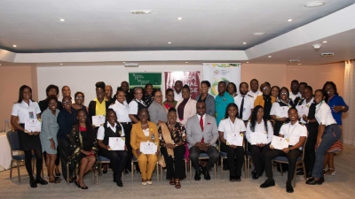 The Minister of Culture, Gender, Entertainment and Sport, the Honourable Olivia Grange, centre, and the Permanent Secretary, DeanRoy Bernard join participants and trainers at work shop on cultural property in Montego Bay, St James