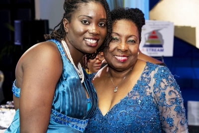 Minister of Culture, Gender, Entertainment and Sport, the Honourable Olivia Grange, shares a moment with adolescent mother Yasheka Brooks.  The Minister has offered to clear the balance on Miss Brooks&#039; tuition fees.