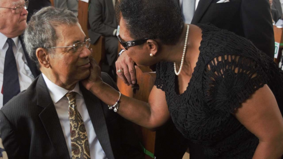 Minister of Culture, Gender, Entertainment and Sport, the Honourable Olivia Grange (right) greets the former Deputy Prime Minister, the Honourable Dr Kenneth Baugh