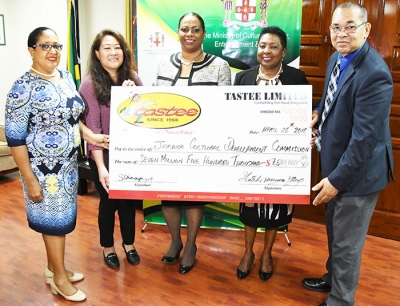 The Honourable Olivia Grange, Minister of Culture, Gender, Entertainment and Sport poses with the replica sponsorship cheque for the Jamaica Independence Festival Song Competition 2018 with Mrs. Patsy Latchman-Atterbury, CEO of Tastee Limited at the Ministry on Thursday, April 26. Joining in from left are Ms. Pat Reid, a member of the Festival Song organizing committee, Ms. Simone Changpong, Director of Tastee Limited and Mr Orville Hill, Interim Executive Director at the JCDC.