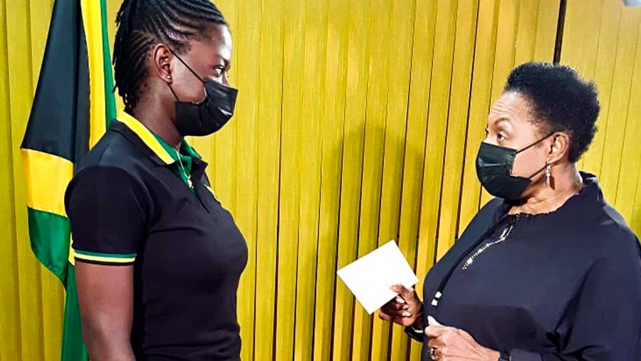 The Minister of Culture, Gender, Entertainment and Sport, the Honourable Olivia Grange, CD, MP presents a cheque for J$500,000 to national women’s cricketer, Rashada Williams, to assist with University expenses.