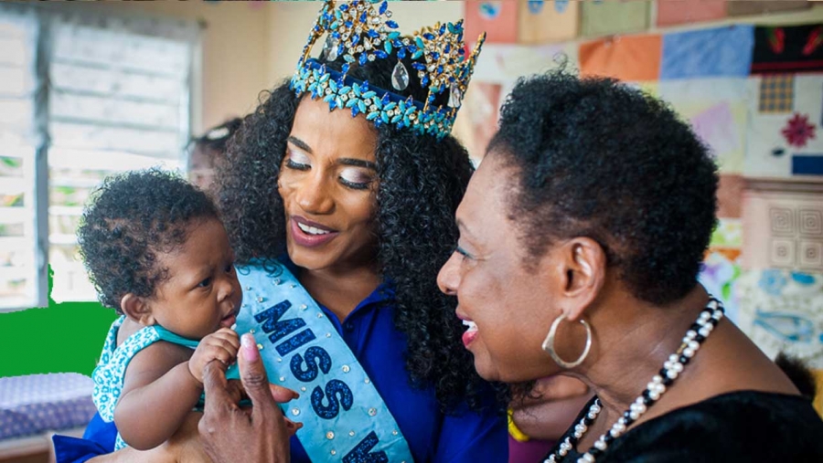 Miss World 2019, Toni-Ann Singh, with a new born at the Women&#039;s Centre of Jamaica Foundation location in Morant Bay, St Thomas.  The Minister of Culture, Gender, Entertainment and Sport, the Honourable Olivia Grange shares the moment.