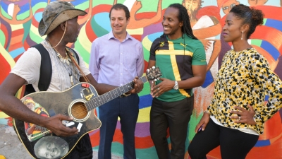 Minister of State in the Ministry of Culture, Gender, Entertainment and Sport, Hon. Alando Terrelonge (second right); and (from second left) Chief Executive Officer, PaperBoyJA, Geoff Lewis; and Co-Founder, Kingston Creative, Andrea Dempster-Chung, are entertained by artiste, Michael Enkrumah, following the launch of Kingston Creative’s ‘First 50 Impact Investment Campaign’ at F&amp;B Downtown, 107 Harbour Street in downtown Kingston on Tuesday (November 27).