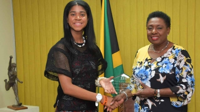 Minister of Culture, Gender, Entertainment and Sport, the Honourable Olivia Grange, receives the DUSUSU Award in the Gender Minister category from the world renowned girls education advocate Zuriel Oduwole.  Minister Grange was honoured for her exemplary work in girls education, gender development and teenage pregnancy.