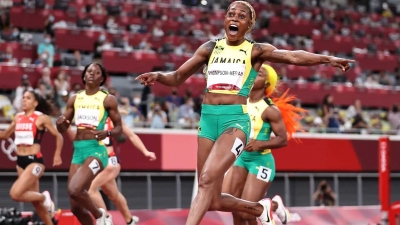Elaine Thompson-Herah celebrates after winning the 100m in Tokyo, setting a new Olympic Record and becoming the fastest woman alive