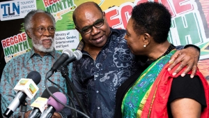 The Minister of Culture, Gender, Entertainment and Sport, the Honourable Olivia Grange (right) embraces the Minister of Tourism, the Honourable Edmund Bartlett, after he announces financial support towards the further development of the Jamaica Music Museum.  Looking on is Director/Curator of the museum, Mr Herbie Miller.