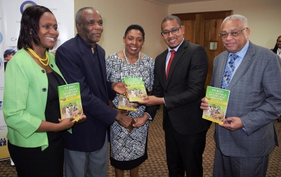 The Honourable Olivia Grange, Minister Culture, Gender, Entertainment and Sport (centre); the Honourable Floyd Green, State Minister in the Ministry of Education Youth and Information (second right), Professor Archibald McDonald, Pro Vice Chancellor and Principal of the University of the West Indies Mona (right) and Keleen Young-Grandison, Project Manager, Sugar Transformation Unit, Ministry of Industry, Commerce, Agriculture and Fisheries (left) receive copies of the book ‘Journey of the Jamaica Sugar Cane Industry 1494-2012’ from author David Crossbourne (second left). The presentation was made at the press launch of the UWI-GOJ Series, Sugar Cane: Recycling Sweetness and Power in Modern Jamaica’ for adults and Ms Sugga, for children.