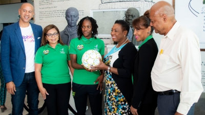 Minister of Culture, Gender, Entertainment and Sport, the Honourable Olivia Grange (3rd right), receives from Reggae Girlz captain Konya Plummer a football signed by members of the team.  The Reggae Girlz departed Jamaica on Monday to begin final preparation for the FIFA Women&#039;s World Cup in France.  Sharing the moment are JFF President, Michael Ricketts (r) and from Caribbean Airlines: Zachary Harding, Director; Alicia Cabrera, Senior Marketing Manager; and Trudy Chin, General Manager. 