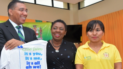 Prime Minister, the Most Honourable Andrew Holness holds up a t-shirt to be worn by volunteers at Labour Day 2019 projects.  Labour Day 2019 on May 23 will be observed under the theme &quot;Child Safety…it’s you, it’s me, it’s all ah we.&quot; Sharing the moment are Minister of Culture, Gender, Entertainment and Sport, the Honourable Olivia Grange (who chairs the National Labour Day Committee) and Ms. Mariko Kagoshima, Country Representative for Unicef Jamaica.  Unicef is working with the National Labour Day Committee in the execution of projects this year.
