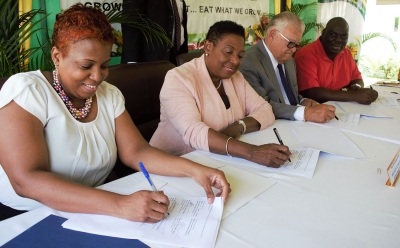 The Minister of Culture, Gender, Entertainment and Sport, the Honourable Olivia Grange and The Honourable Karl Samuda, the Minister of Industry, Commerce, Agriculture and Fisheries sign a Memorandum of Understanding to promote sustainable and productive entrepreneurial activities in order to generate income among disadvantaged women. Also photographed are: Dr. Janice Lindsay, Acting Permanent Secretary in the Ministry Culture, Gender, Entertainment and Sport (l) and Donovan Stanberry, Permanent Secretary in the Industry, Commerce, Agriculture and Fisheries (r). The MOU was signed yesterday (November 1) at the Ministry of Industry, Commerce, Agriculture and Fisheries Hope Gardens location.