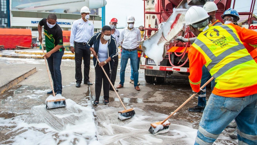 The Minister of Culture, Gender, Entertainment and Sport, the Honourable Olivia Grange (3rd left) and the Mayor of Kingston, Senator Councillor Delroy Williams (left), join the work crew from Carib Cement Company and Jamaica Pre-Mix in a Labour Day sanitisation project at Mandela Park in Half Way Tree.  Also pictured are: Sales Manager at Carib Cement Garen Williams; Managing Director of Jamaica Pre-Mix Limited, John Valentine; and Industrial and Builders Manager at Carib Cement, Andre Nelson.