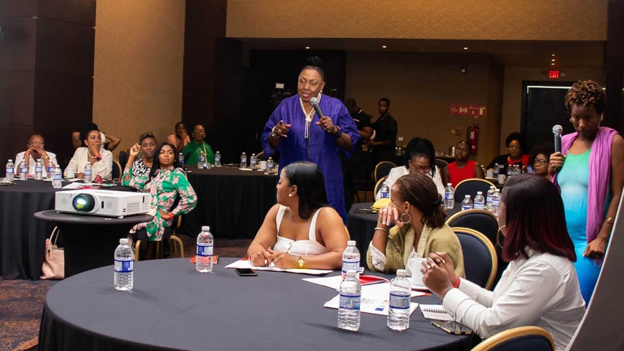 Minister Grange makes a point at a training retreat for women parliamentarians and councillors