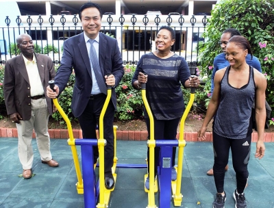 Getting Fit. Minister of Culture, Gender, Entertainment and Sport, the Honourable Olivia Grange and Li Sen, President, Board of Supervision, China Communications Construction Company try out newly installed equipment at Emancipation Park earlier today (Wednesday). The gym equipment was donated by China Harbour Engineering Company. The donation supports the Ministry’s goal for a more active and healthier society as outlined in the National Sport Policy. Looking on are: Fitness Instructor Davina Barrett (right); Member of Parliament East Central St. Catherine, Alando Terrelonge (partially hidden) and Doran Dixon, Director, National Housing Trust (left).