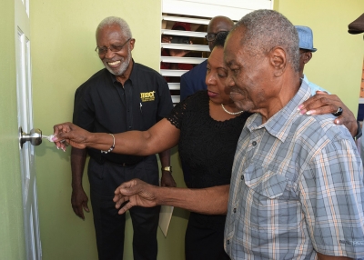 The Honourable Olivia Grange, Minister of Culture, Gender, Entertainment and Sport, assists former Jamaica boxing champion George ‘Bunny’ Grant, in opening the door to his newly refurbished home on Weymouth Drive yesterday (Wednesday). Looking on are: Leroy Brown, General Secretary, Jamaica Boxing Board of Control and Denzil Wilks, General Manager, Sports Development Foundation (l-r). The refurbishing project was undertaken by the Sports Development Foundation.