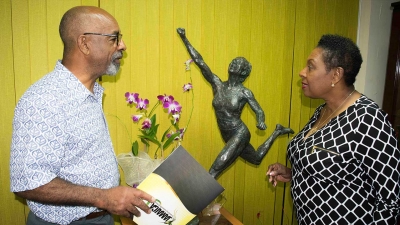 The Minister of Culture, Gender, Entertainment and Sport, the Honourable Olivia Grange (right) discusses the design of the Shelly-Ann Fraser Pryce statue with sculptor Basil Watson.