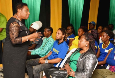 The Honourable Olivia Grange, Minister of Culture, Gender, Entertainment and Sport addresses a group of netball and football players and officials at a ceremony to launch the Final Round of the INSPORTS Football and Netball Community Competitions.