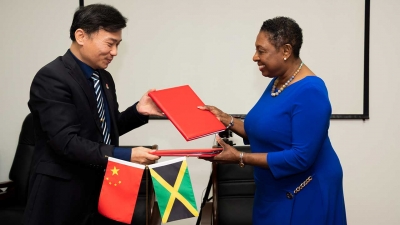 Minister of Culture, Gender, Entertainment and Sport, the Honourable Olivia Grange (right) signs major sport cooperation agreement with the General Manager of the state-owned China Sport International Company, Mr Lu Guoguang (left).  Under the agreement, more than 400 athletes from Jamaica will receive high level training at specialised centres in China over the next three years.