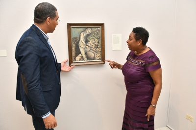 Minister of Culture, Gender, Entertainment and Sport, the Honourable Olivia Grange points out a feature in John Dunkley&#039;s piece titled The Shepherd to Prime Minister, the Most Honourable Andrew Holness. The Prime Minister declared open the exhibition John Dunkley: Neither Day nor Night on Sunday at the National Gallery of Jamaica. The Good Shepherd is an allegorical portrait of National Hero, the Right Excellent Sir Alexander Bustamante.