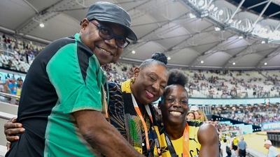 Jamaican sprinter Shericka Jackson (right) is congratulated by the Minister of Culture, Gender, Entertainment and Sport, the Honourable Olivia Grange (centre) and the Minister of Tourism, the Honourable Edmund Bartlett (left) after setting a new championship record of 21.41 to win the women&#039;s 200m final at the World Athletics Championships in Budapest, Hungary on Friday.