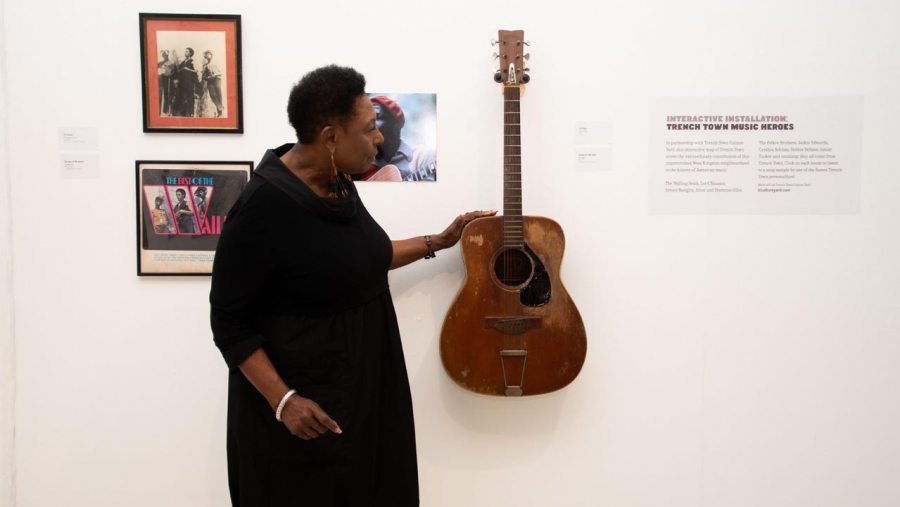 The Minister of Culture, Gender, Entertainment and Sport, the Honourable Olivia Grange, admires a guitar of the late Reggae musician Joe Higgs, which is part of the Jamaica Jamaica! exhibition now on show at the National Gallery of Jamaica until the end of June.  Minister Grange launched the exhibition as a major activity for Reggae Month.