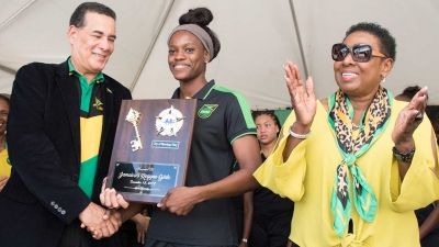 The Minister of Culture, Gender, Entertainment and Sport, the Honourable Olivia Grange, applauds as the Mayor of Montego Bay, His Worship Councillor Homer Davis presents the Key to the City of Montego Bay to the captain of the Reggae Girlz, Konya Plummer.
