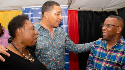 Prime Minister, the Most Honourable Andrew Holness (centre) shares a light moment with the Minister of Culture, Gender, Entertainment and Sport, the Honourable Olivia Grange (left) and veteran broadcaster, Barry G (right) at Rebel Salute 2020