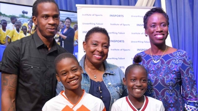 The Minister of Culture, Gender, Entertainment and Sport, the Honourable Olivia Grange (centre); Ian ‘Pepe’ Goodison, former national football player and ambassador for the INSPORTS Primary School Football Competition and Dr Paula Daley-Morris, President, Netball Jamaica with Anthony McDonald, captain, Denham Town Primary School football team (front, left) and Shawna-Kay Davis, captain Greenwich Primary School netball team.