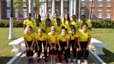 Members of the women’s national football team, the Reggae Girlz, share a photo opportunity after receiving the Key to Spanish Town on December 18