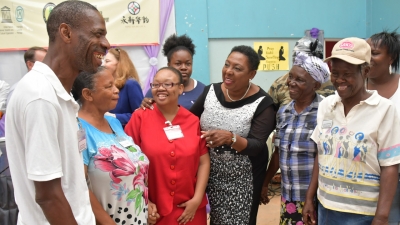 The Minister of Culture, Gender, Entertainment and Sport, the Honourable Olivia Grange (centre) in conversation with participants of the workshop on intangible cultural heritage being held at the Trench Town Multipurpose Centre.